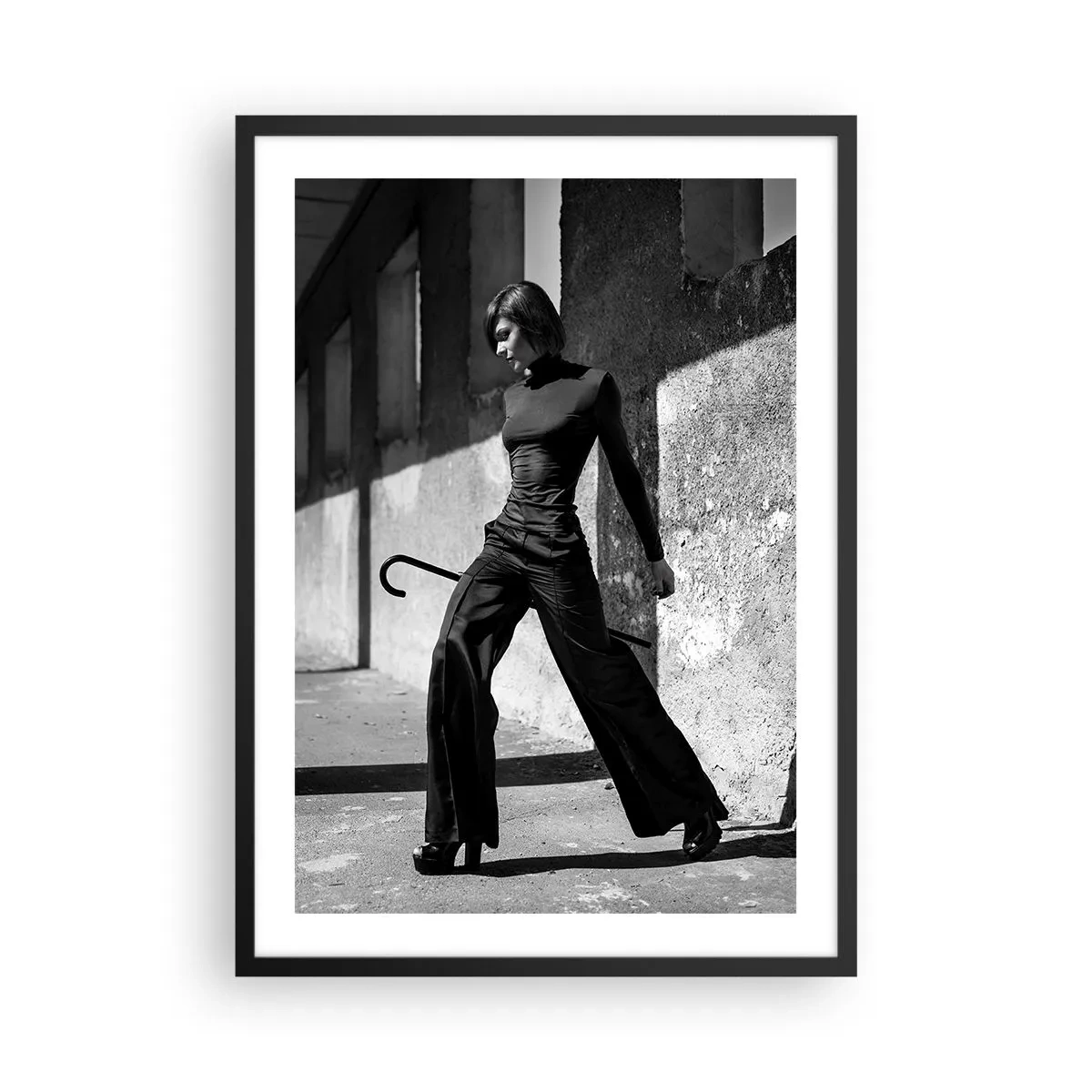 Poster in black frame - A woman in an elegant outfit with a cane against the backdrop of austere architecture - 50x70cm - City Chic - Modern wall decoration for the living room and bedroom ARTTOR
