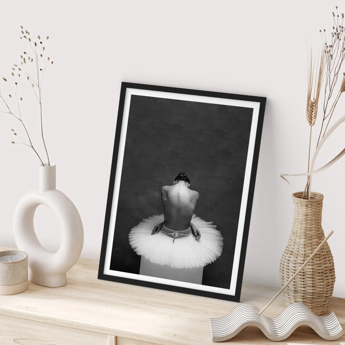 Poster in black frame - Black and white portrait of a ballerina sitting on a platform - 50x70cm - It Is Blossoming - Modern wall decoration for the living room and bedroom ARTTOR