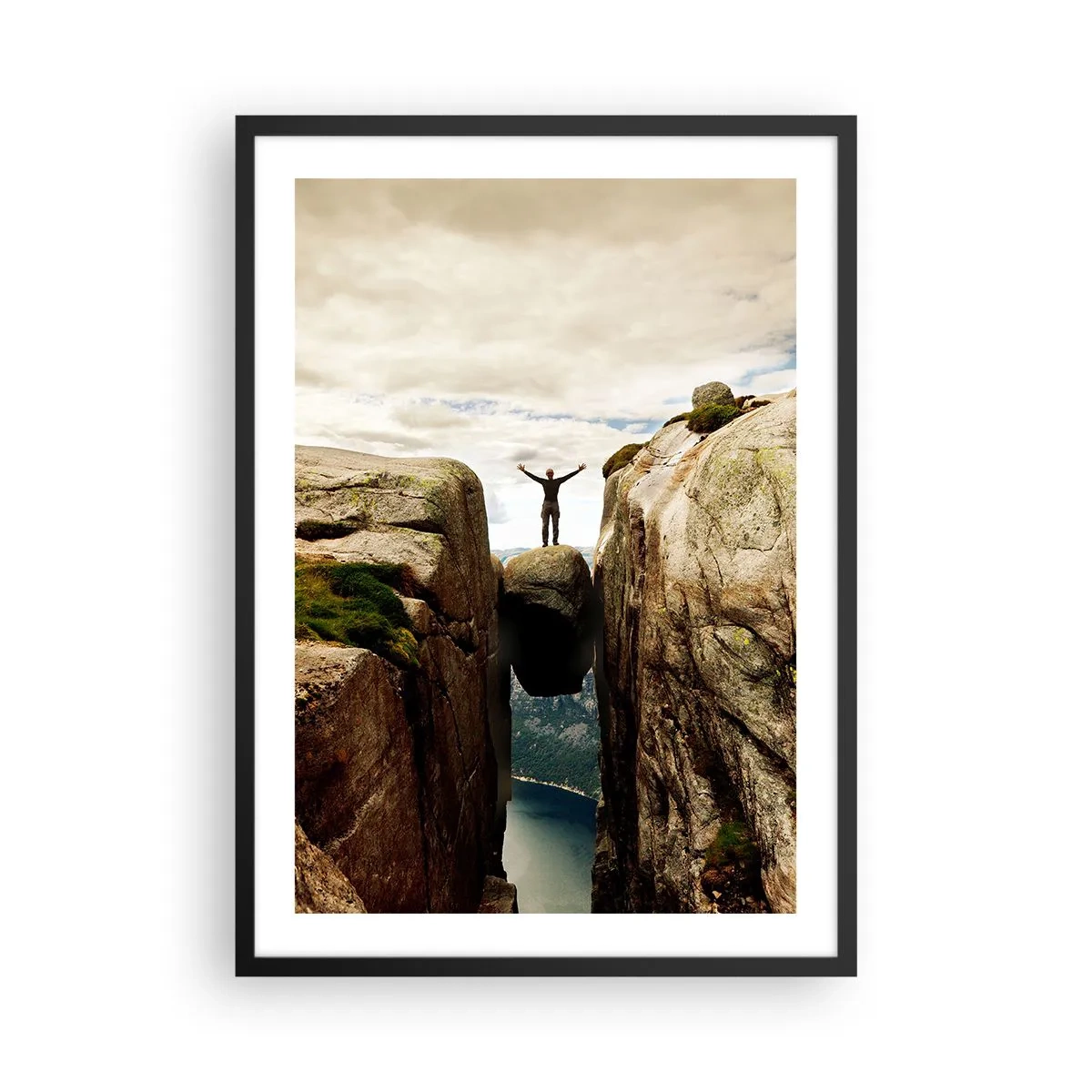 Poster in black frame - man standing on a rock suspended between cliffs - 50x70cm - How Am I?! - Modern wall decoration for the living room and bedroom ARTTOR