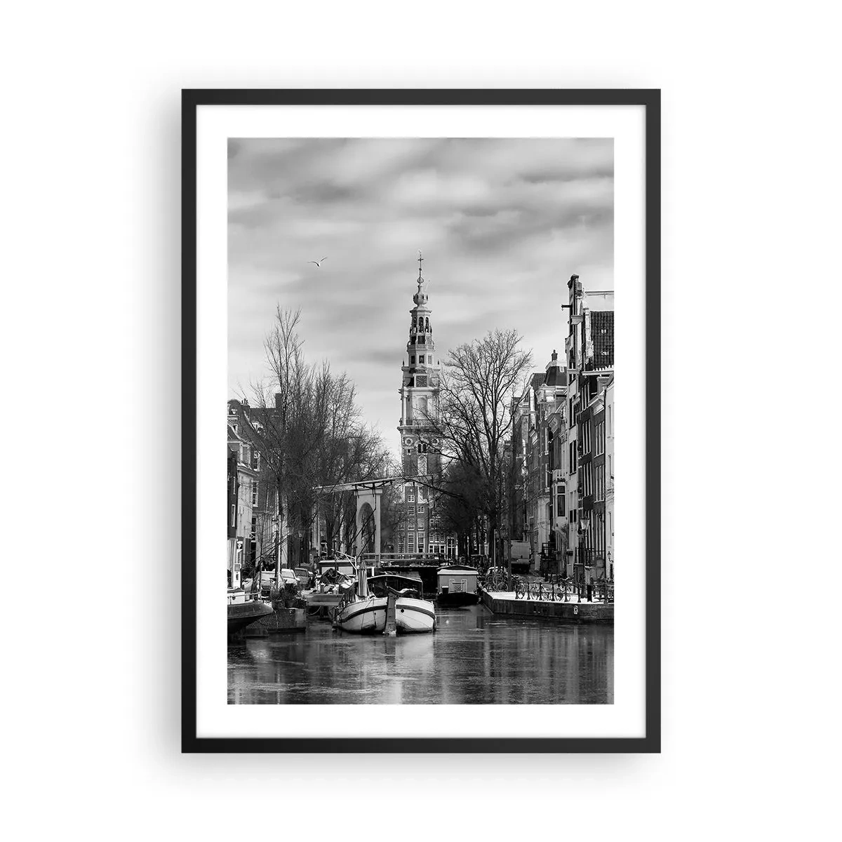 Poster in black frame - A black and white view of the canal with a historic tower in the background. - 50x70cm - Amsterdam Atmosphere - Modern wall decoration for the living room and bedroom ARTTOR