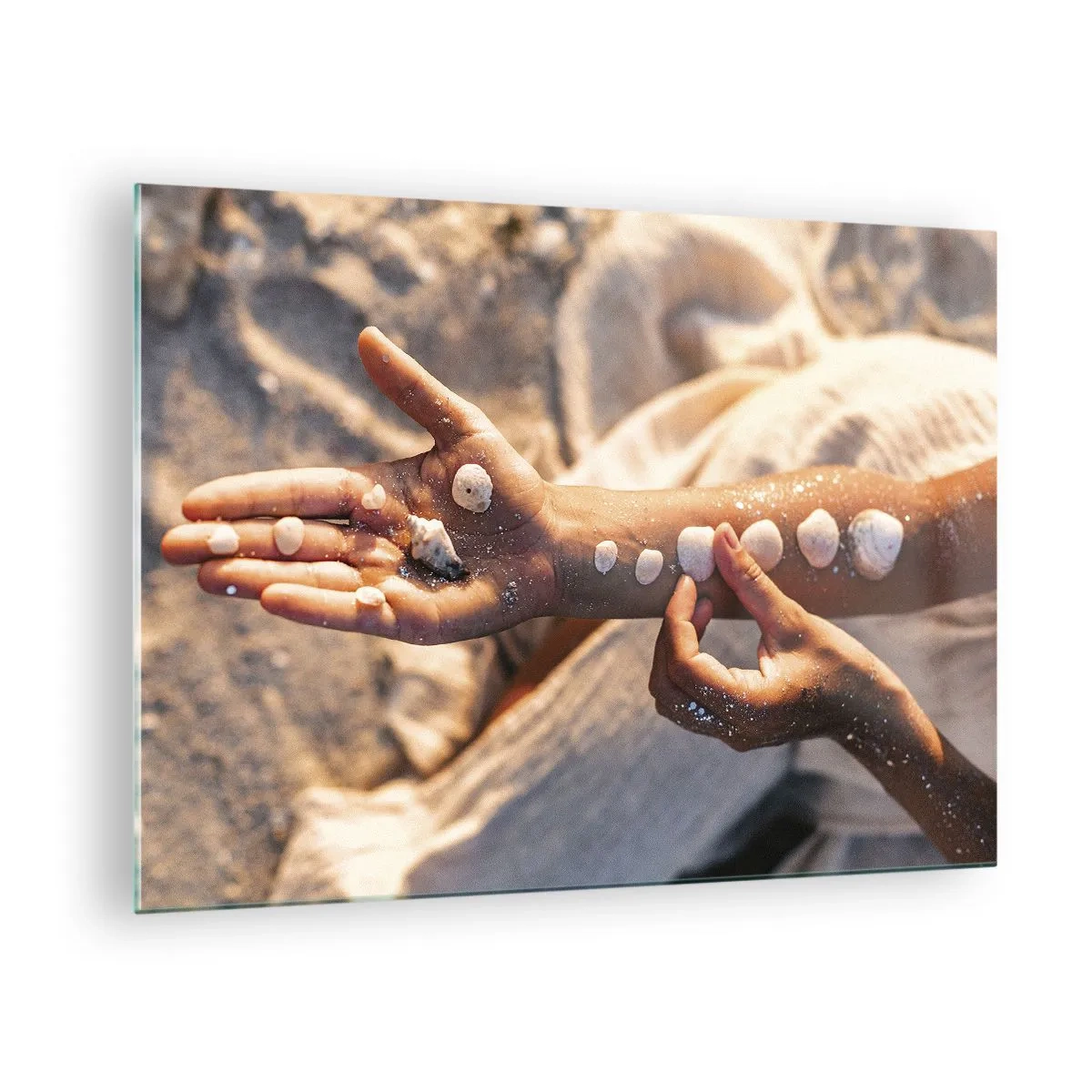 Glass picture - Child's hands with seashells on a background of sand and fabric - 70x50cm - Beauty at Hand - Modern wall decoration for the living room and bedroom ARTTOR