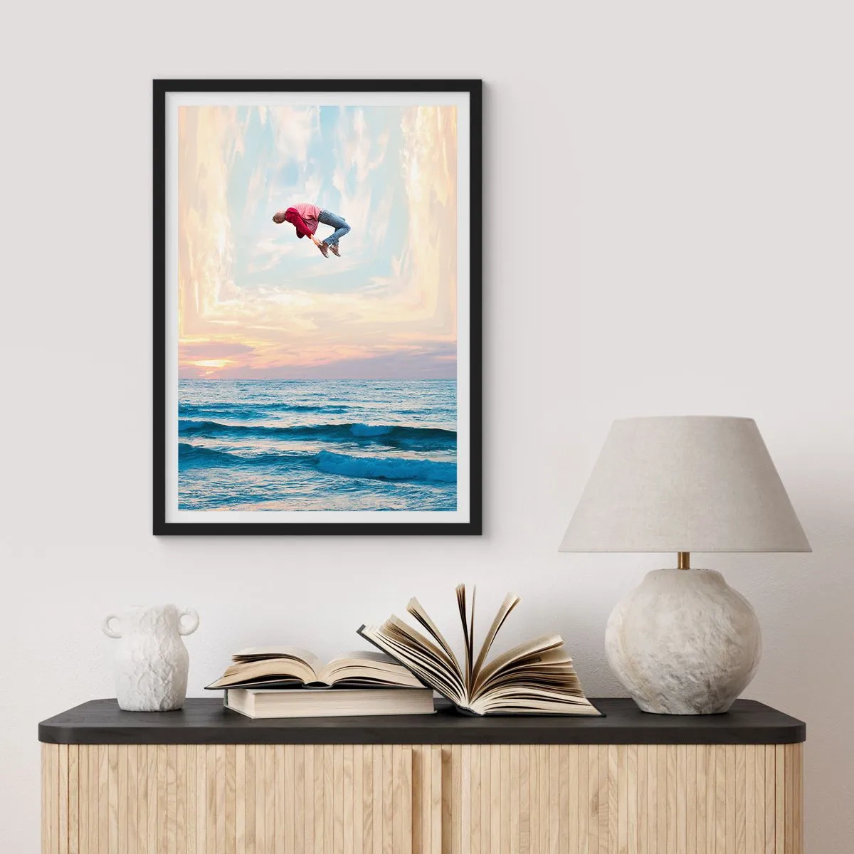 Poster in black frame - man jumps into the sky over the ocean at sunset - 50x70cm - To Another Dimension - Modern wall decoration for the living room and bedroom ARTTOR
