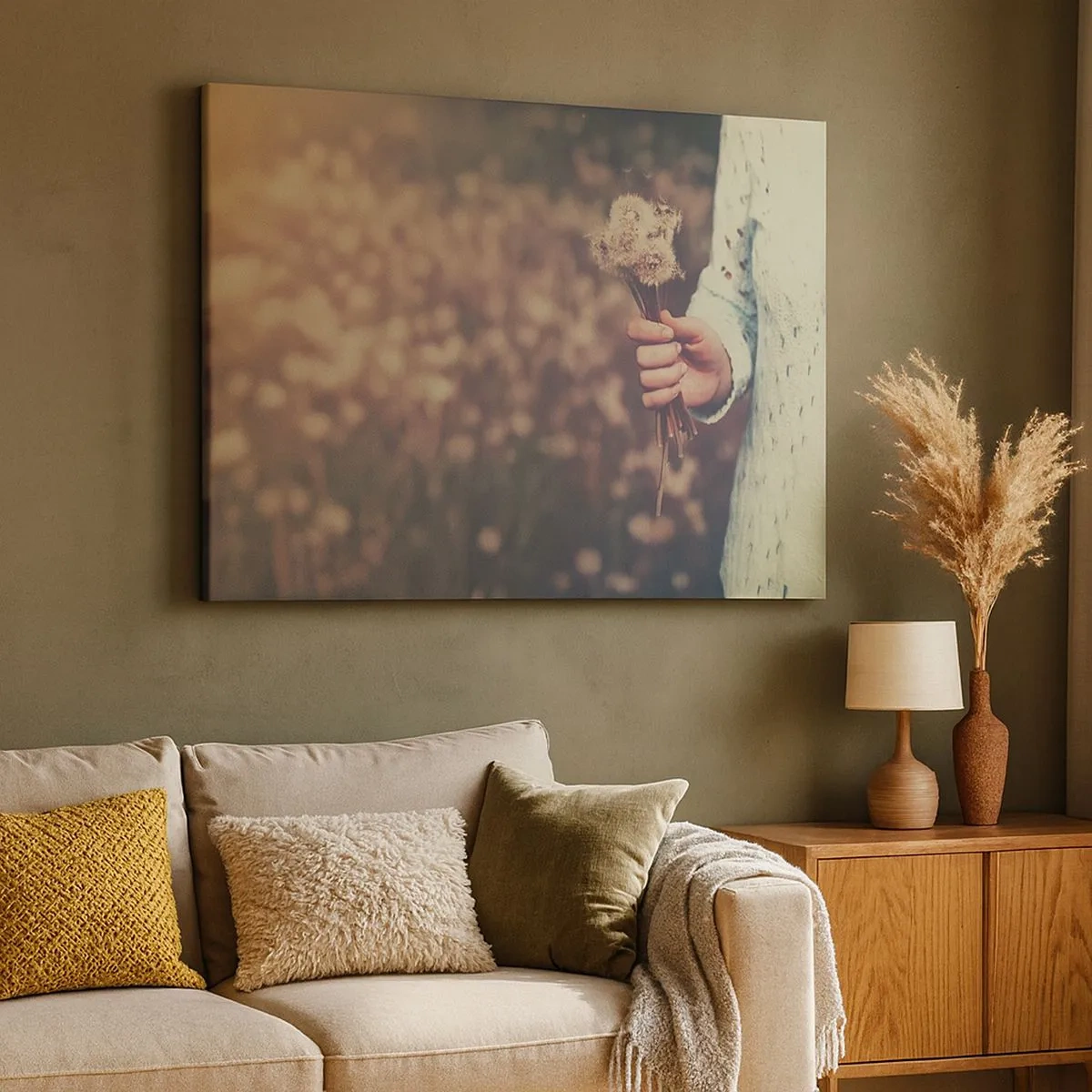 Canvas picture - A hand holding dandelions against a blurred background of a field full of flowers. - 70x50cm - Stop Them, Please - Modern wall decoration for the living room and bedroom ARTTOR