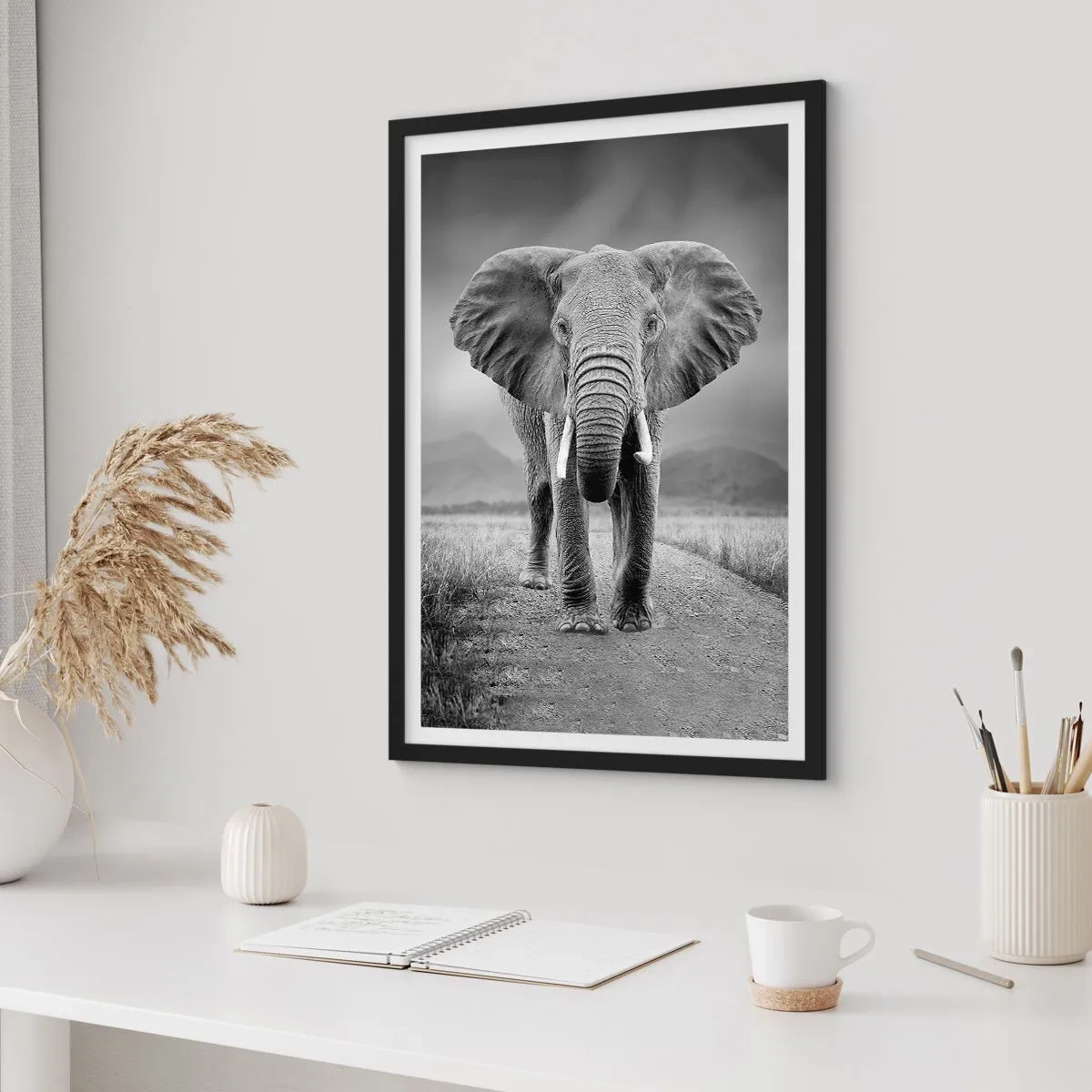Poster in black frame - An elephant against an African landscape in black and white - 50x70cm - Welcoming of the Host - Modern wall decoration for the living room and bedroom ARTTOR