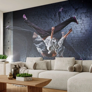 Photo Wallpaper Standard Eco - A break dancer in dynamic movement against a brick wall. - 100x70cm - Street Star - Modern wall decoration for the living room and bedroom ARTTOR